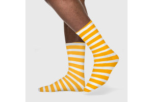 Feet wearing striped yellow and white crew socks