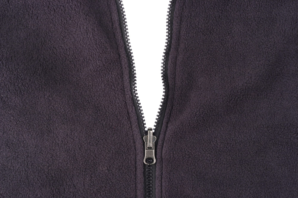 Black fleece jacket being unzipped