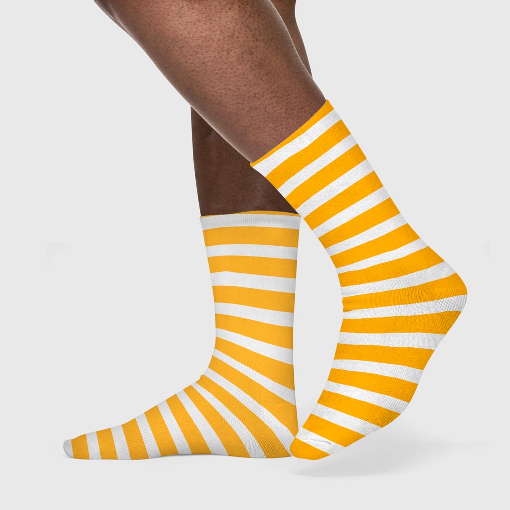 Feet wearing striped yellow and white crew socks